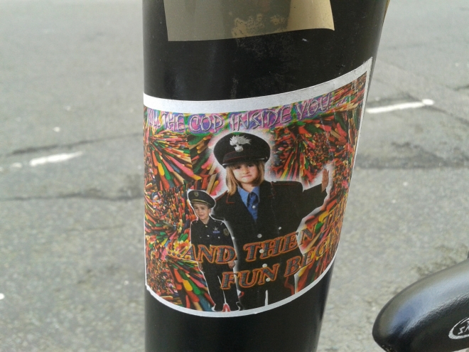 The text on this sticker is difficult to make out, but it reads 'Kill the cop inside you... and then the fun begins' (Bloomsbury, 17/03/15).